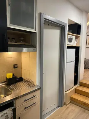 a kitchen with a door leading into a kitchen at CITY CENTER Apartment in Belgrade