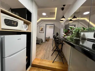 a kitchen with a white refrigerator and a microwave at CITY CENTER Apartment in Belgrade