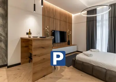 a bedroom with a bed and a tv in a room at Silver Luxury Suites in Belgrade
