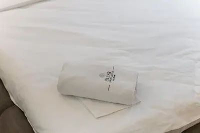 a white towel sitting on top of a bed at Silver Luxury Suites in Belgrade