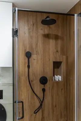 a shower with a black shower head in a bathroom at Silver Luxury Suites in Belgrade
