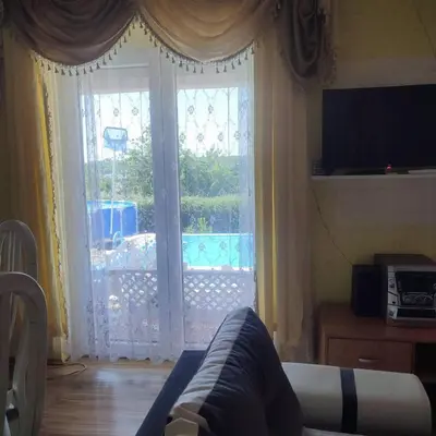 a living room with a large glass door to a patio at Lux Apartmans-VILA MALI RAJ in Udovice