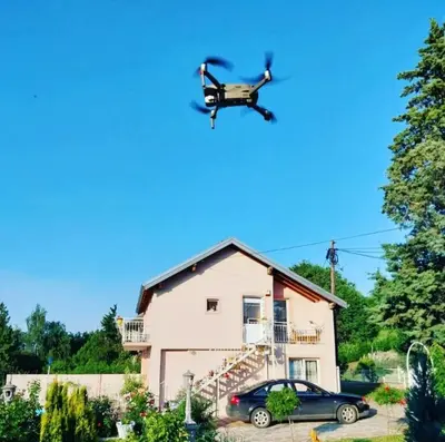 a drone flying over a house with a car at Lux Apartmans-VILA MALI RAJ in Udovice
