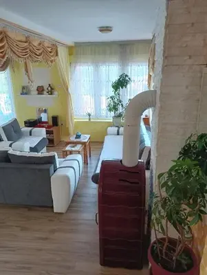 a living room with a fire place in the middle at Lux Apartmans-VILA MALI RAJ in Udovice