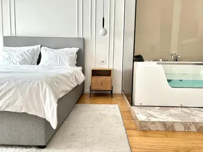 a bedroom with a bed and a sink at Bulevard Luxury Suites in Belgrade