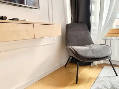 a chair sitting in a room next to a window at Bulevard Luxury Suites in Belgrade
