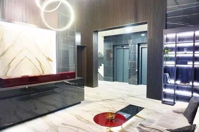 a lobby with a couch and a large mirror at Bulevard Luxury Suites in Belgrade