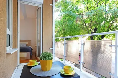 a balcony with a table and a large window at Lion Apartment - Belgrade in Belgrade