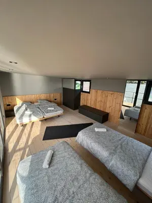 a large bedroom with two beds and a couch at Splav Shoom in Ostružnica