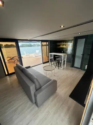 a living room with a couch and a table at Splav Shoom in Ostružnica