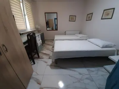 a bedroom with two beds and a mirror at Belgrade city residence, silent and comfortable in Belgrade