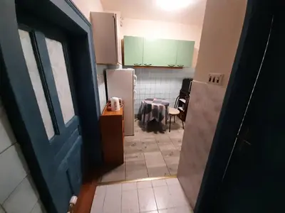 a room with a kitchen with a table and a refrigerator at Belgrade city residence, silent and comfortable in Belgrade