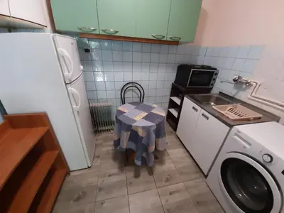 a small kitchen with a table and a washing machine at Belgrade city residence, silent and comfortable in Belgrade