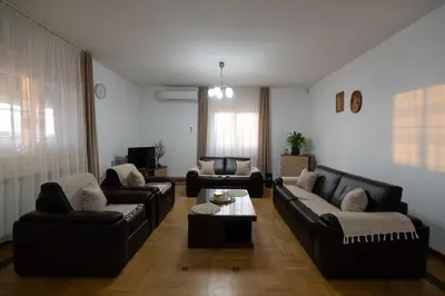 a living room with couches and a coffee table at Green Art House in Kovilovo