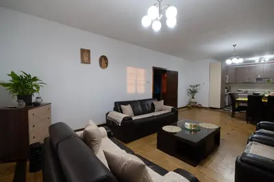 a living room with a couch and a table at Green Art House in Kovilovo