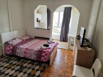 a bedroom with a pink bed and a mirror at Venac in Belgrade