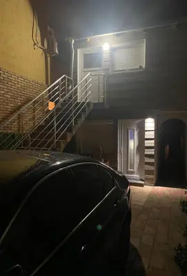 a car parked in front of a building with a staircase at Apartment Antik Belgrade in Belgrade