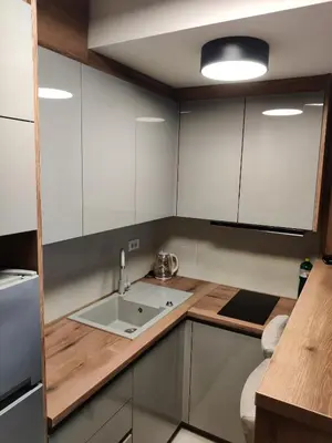 a kitchen with white cabinets and a sink at Apartment Relax 1 in Belgrade