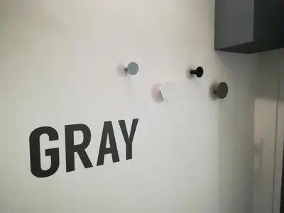 a sign that says gray on a white wall at Gray apartment in Čukarica