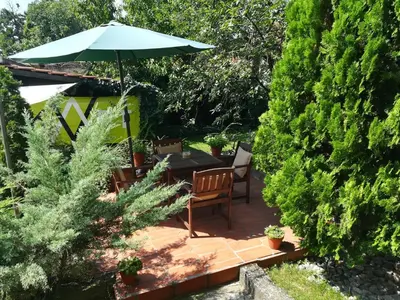 a patio with a table and an umbrella at Gray apartment in Čukarica