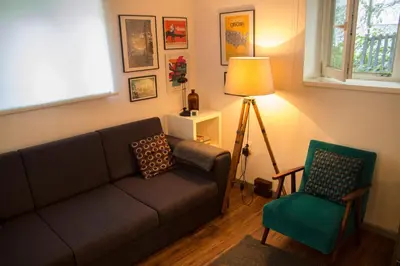 a living room with a couch and a chair at Gray apartment in Čukarica