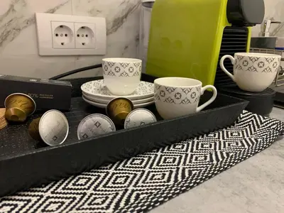 a tray with two cups and plates on a table at DM apartman Beograd in Vračar (historical)