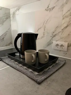 a coffee pot and two cups on a tray at DM apartman Beograd in Vračar (historical)