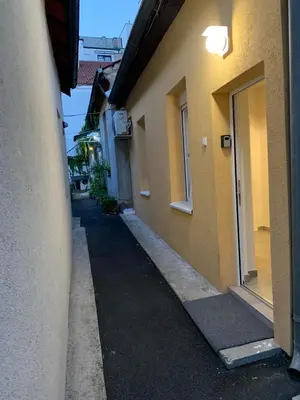 an empty alley between two buildings with a building at DM apartman Beograd in Vračar (historical)