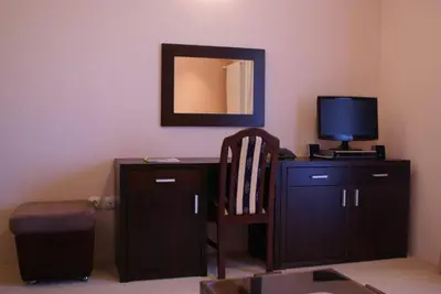 a room with a desk with a television and a chair at Vila Vidikovac Arandjelovac in Arandjelovac