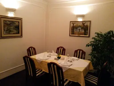 a table in a restaurant with a white table cloth at Vila Vidikovac Arandjelovac in Arandjelovac