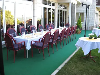a group of tables and chairs on a patio at Vila Vidikovac Arandjelovac in Arandjelovac