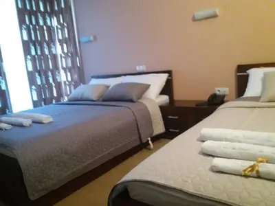 a bedroom with two beds with towels on them at Vila Vidikovac Arandjelovac in Arandjelovac
