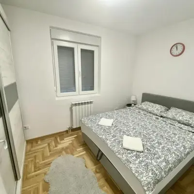 a bedroom with a bed with two napkins on it at BellaVista apartman in Stara Pazova