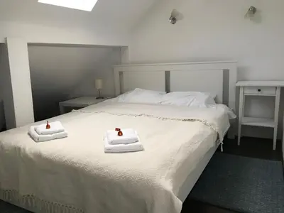 a bedroom with a bed with two towels on it at Centrum in Belgrade