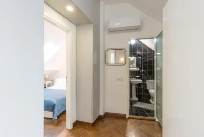a bedroom with a bed and a bathroom with a mirror at Centrum in Belgrade