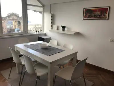 a dining room with a table and chairs and a window at Centrum in Belgrade
