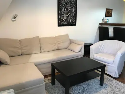 a living room with a couch and a table and a chair at Centrum in Belgrade