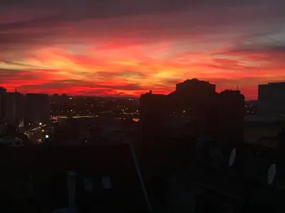 a sunset in a city with a red sky at Centrum in Belgrade