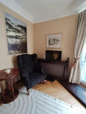 a living room with a chair and a television at Oaza 26 deo 2 in Belgrade