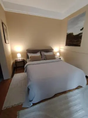 a bedroom with a large white bed with two lamps at Oaza 26 deo 2 in Belgrade