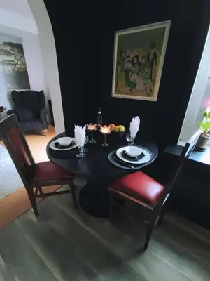 a dining room with a black table and chairs at Oaza 26 deo 2 in Belgrade