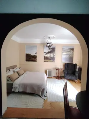 a bedroom with a bed and a chair at Oaza 26 deo 2 in Belgrade