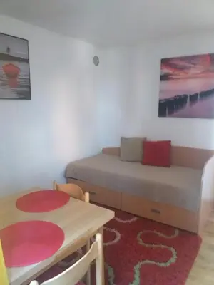 a small room with a table and a bed and a table and chair at Taras House in Zvezdara