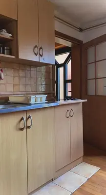 a kitchen with wooden cabinets and blue counter tops at Taras House in Zvezdara