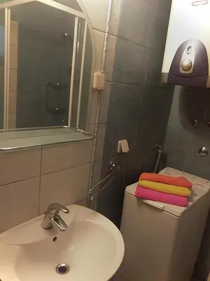 a bathroom with a sink and a toilet with a mirror at Taras House in Zvezdara