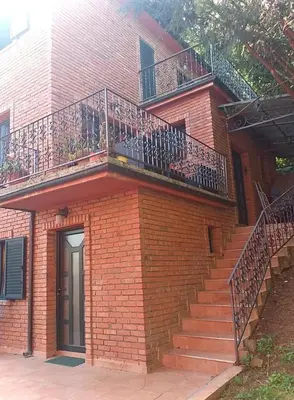 a brick building with stairs and a balcony at Taras House in Zvezdara
