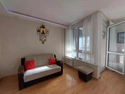 a living room with a couch and a window at Xenia apartments in Belgrade