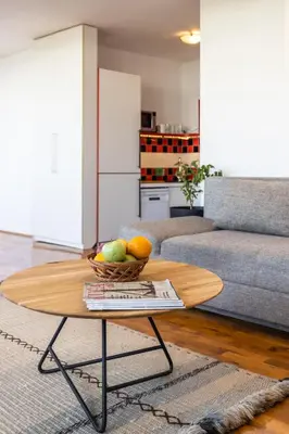 a living room with a bowl of fruit on a coffee table at Spacious Loft with one bedroom and a big terrace in Belgrade