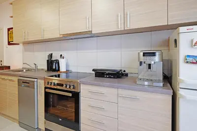a kitchen with a stove top oven and a coffee maker at Apartment Paradise Exotic Star in Belgrade