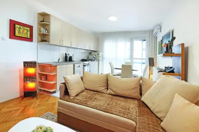a living room with a couch and a kitchen at Apartment Paradise Exotic Star in Belgrade